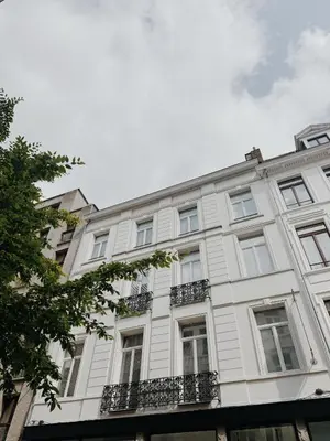 a white building with windows and balconies at The 1894 Residence by Domani Hotels in Antwerp