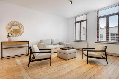 a living room with a couch and a table and chairs at The 1894 Residence by Domani Hotels in Antwerp