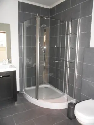 a bathroom with a shower with a toilet and a sink at B&B Caramel in Turnhout