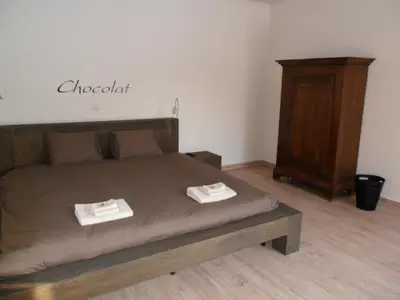 a bedroom with a bed with two plates on it at B&B Caramel in Turnhout