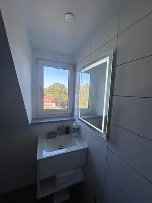 a white bathroom with a sink and a window at Elegance & Comfort Brand New Apartment near to Atomium in Brussels