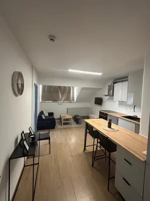 a kitchen and living room with a table and chairs at Elegance & Comfort Brand New Apartment near to Atomium in Brussels