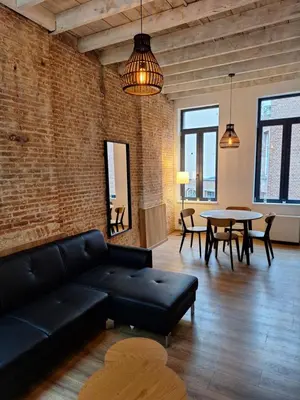 a living room with a couch and a table at Huis ALNA 4 in Mechelen