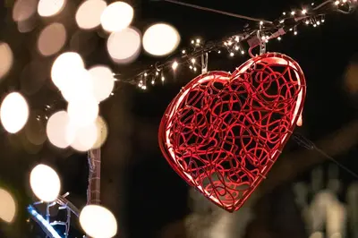 a red heart hanging from a string with lights at Huis ALNA 4 in Mechelen