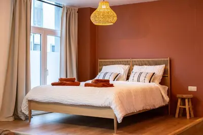 a bedroom with a bed with two brown towels on it at Romantische Studio in Harmoniewijk in Antwerp