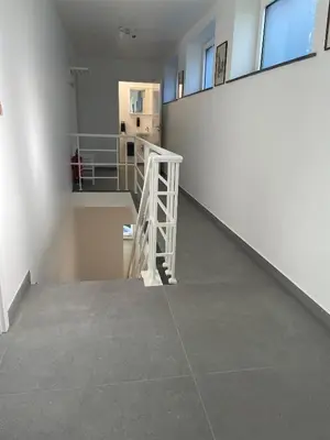 an empty room with a staircase in a building at Akuta City Flat Leuven in Leuven
