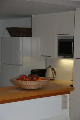 a bowl of fruit on a counter in a kitchen at The Little House in Beersel