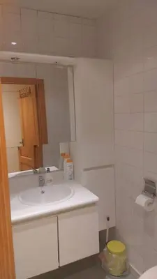 a white bathroom with a sink and a mirror at Charming 1-Bedroom Apartment in Brussels
