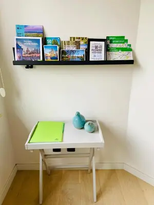 a white table with a green laptop on top of it at B&B Aline Florentine - adults only - Luxury B&B - Chambres d'Hôtes - Zimmer Frei in Kortenberg