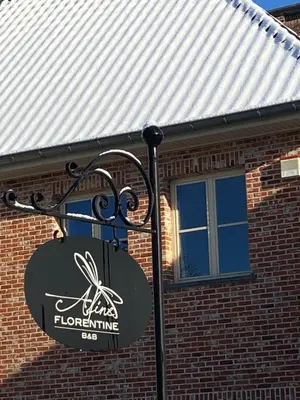 a sign in front of a brick building at B&B Aline Florentine - adults only - Luxury B&B - Chambres d'Hôtes - Zimmer Frei in Kortenberg