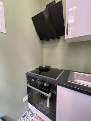 a small kitchen with a stove and a sink at Apartament in Brussels
