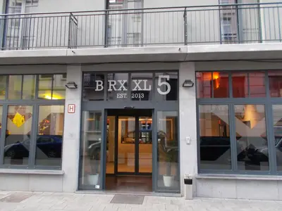a building with a clock on the front of it at Brxxl 5 City Centre Hostel in Brussels