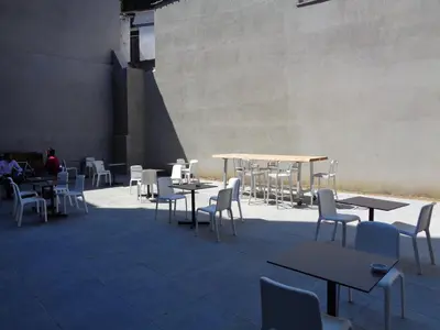 a group of tables and chairs in a building at Brxxl 5 City Centre Hostel in Brussels