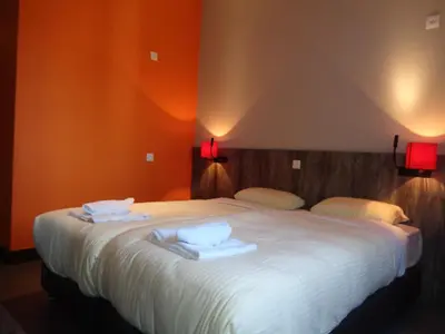 a bedroom with a large white bed with two pillows at Brxxl 5 City Centre Hostel in Brussels