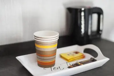 a coffee cup sitting on top of a plate with aucer at Brxxl 5 City Centre Hostel in Brussels