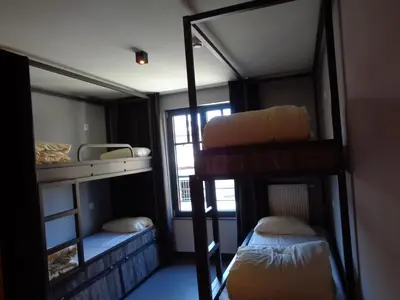 a room with three bunk beds and a window at Brxxl 5 City Centre Hostel in Brussels
