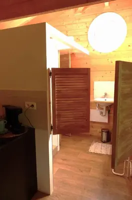 a bathroom with a sink and a door with a sink at Wood-and-work in Wavre