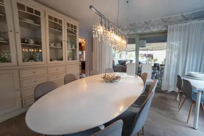 a dining room with a white table and chairs at Vakantievilla met zwembad, wellness en glamping in Paal/Beringen in Beringen