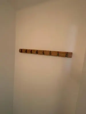 a wooden shelf on the wall of a room at Cosy apartment with park view in Ghent