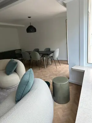 a living room with a couch and a table at Cosy apartment with park view in Ghent