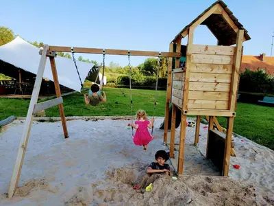 two children playing in the sand on a swing set at Parkhoeve Vakantiewoning voor 21 personen in Ham