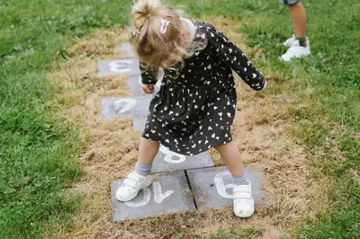 a little girl playing with chalk on a sidewalk at Parkhoeve Vakantiewoning voor 21 personen in Ham