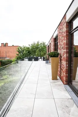 an empty courtyard of a building with a glass walkway at Brand New Apartment Sint-niklaas in Sint-Niklaas