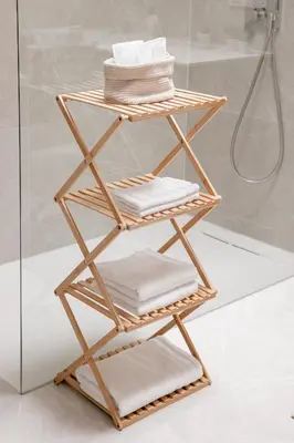 a bamboo towel rack with towels on it in a bathroom at Brand New Apartment Sint-niklaas in Sint-Niklaas