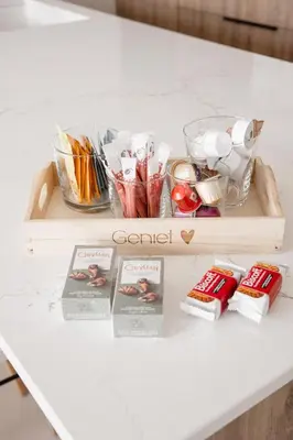 a table with a tray of candy on a table at Brand New Apartment Sint-niklaas in Sint-Niklaas