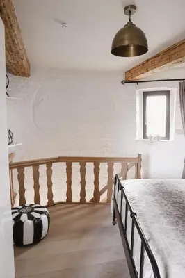 a bedroom with a large bed and a window at The Millhouse in Sint-Niklaas