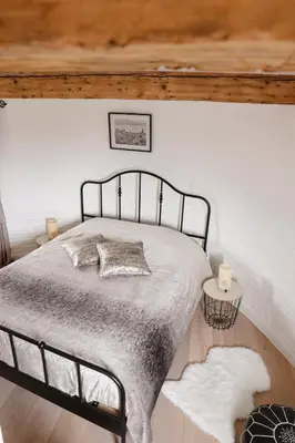 a bedroom with a bed with a metal frame at The Millhouse in Sint-Niklaas