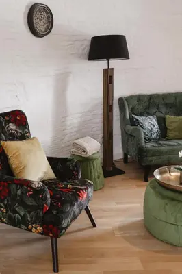 a living room with a couch and a chair at The Millhouse in Sint-Niklaas