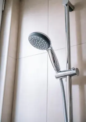 a shower with a shower head in a bathroom at Appartement vlakbij Antwerpen centrum! in Antwerp