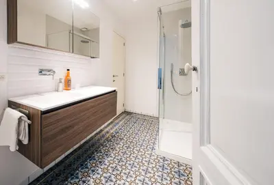 a bathroom with a sink and a shower at Your homestay in a bibliophile mansion in Antwerp