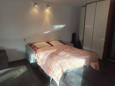 a bedroom with a bed with two pillows on it at Lux & Cozy Apt + Garden +Jaccuzi in Antwerp