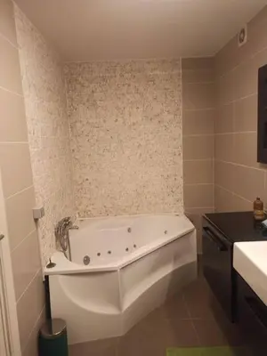 a white bath tub in a bathroom with a sink at Lux & Cozy Apt + Garden +Jaccuzi in Antwerp