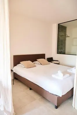 a bedroom with a large bed with white sheets at The Banker Antwerpen - Free Parking in Antwerp