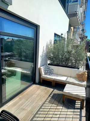 a balcony with two benches and a glass door at The Banker Antwerpen - Free Parking in Antwerp