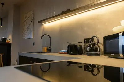 a kitchen with a counter top with a sink at Cityview Modern Apartment with Balcony in Antwerp
