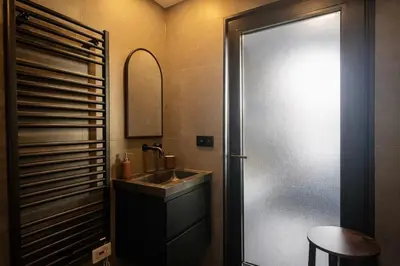 a bathroom with a sink and a mirror at Cityview Modern Apartment with Balcony in Antwerp