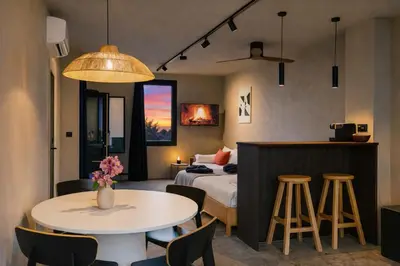 a hotel room with a bed and a table and chairs at Cityview Modern Apartment with Balcony in Antwerp
