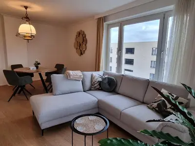 a living room with a couch and a table at COSY APPARTMENT 3 BEDSROOM in Antwerp