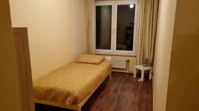 a small bedroom with a bed and a window at COSY APPARTMENT 3 BEDSROOM in Antwerp