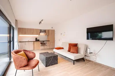 a living room with a couch and chairs and a tv at K&Y suites 3 Brussels airport 500m! in Zaventem