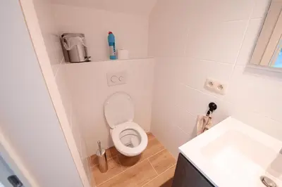 a small bathroom with a toilet and a sink at K&Y suites 3 Brussels airport 500m! in Zaventem