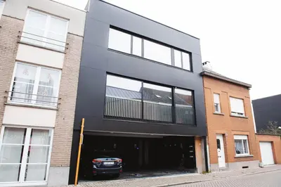 a black building with a car parked in it at K&Y suites 3 Brussels airport 500m! in Zaventem