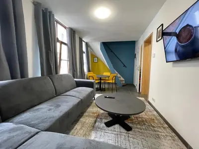 a living room with a couch and a table at Apartament duplex in Brussels