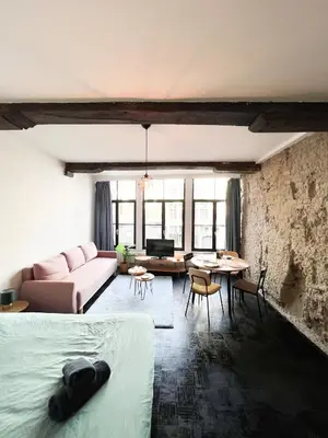 a living room with a couch and a table at Cosy Appartement Nammos 1 - 4 p in Antwerp