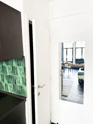 a room with a door and a living room at Cosy Appartement Nammos 1 - 4 p in Antwerp