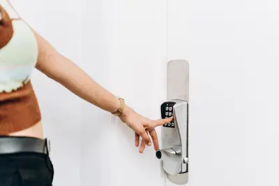 a woman is unlocking a door with her hand at Atomihotel: Contemporary Comfort Steps from the Atomium! in Brussels